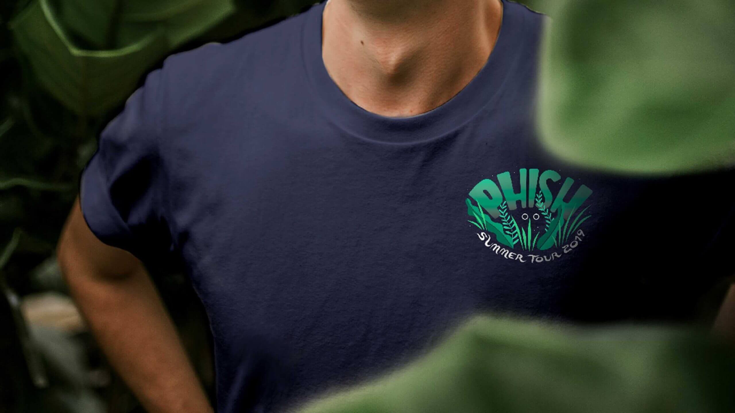 A person wearing a blue Phish tshirt which reads "Summer Tour 2019"