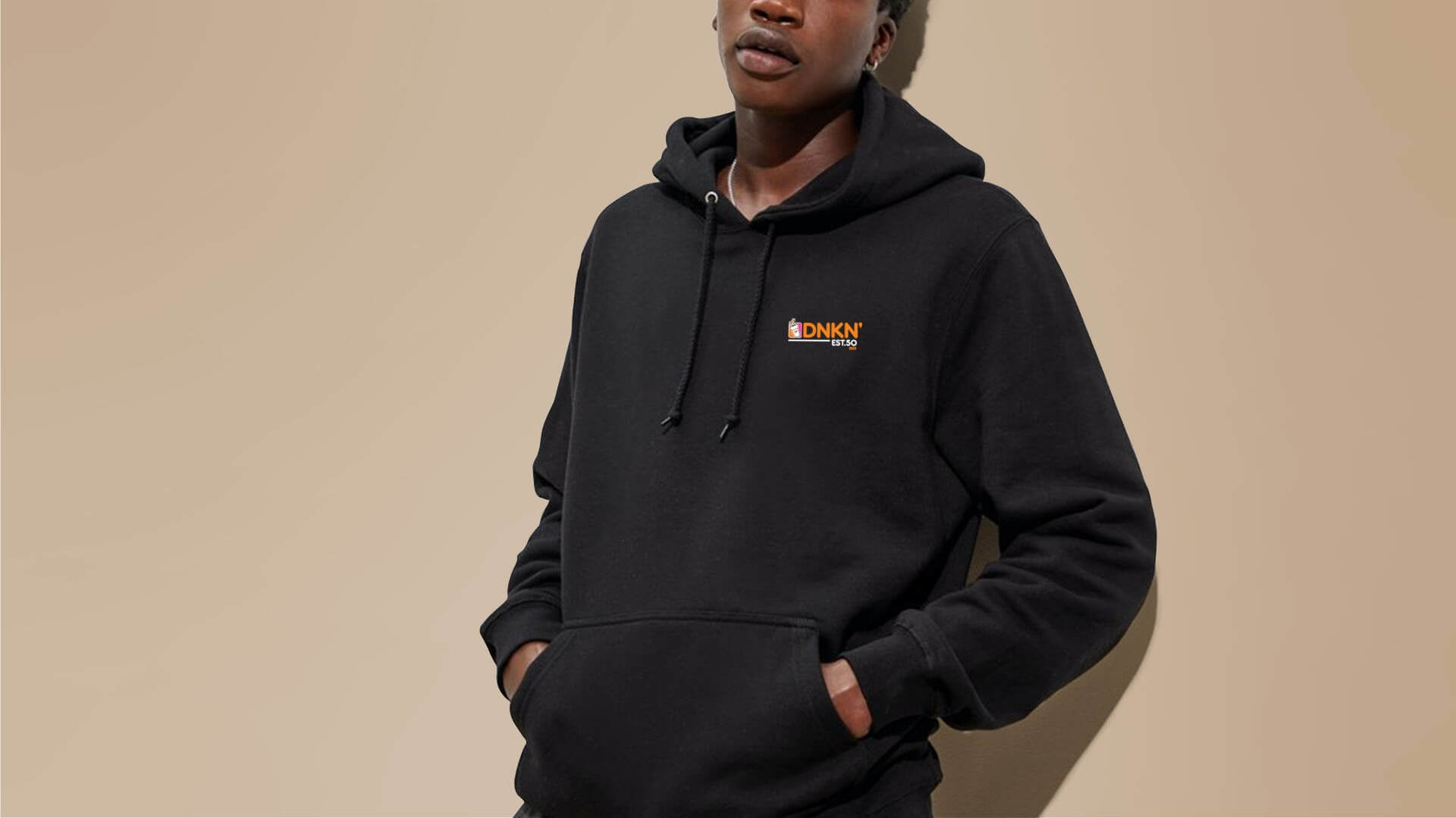 A person in a black Dunkin' hoodie